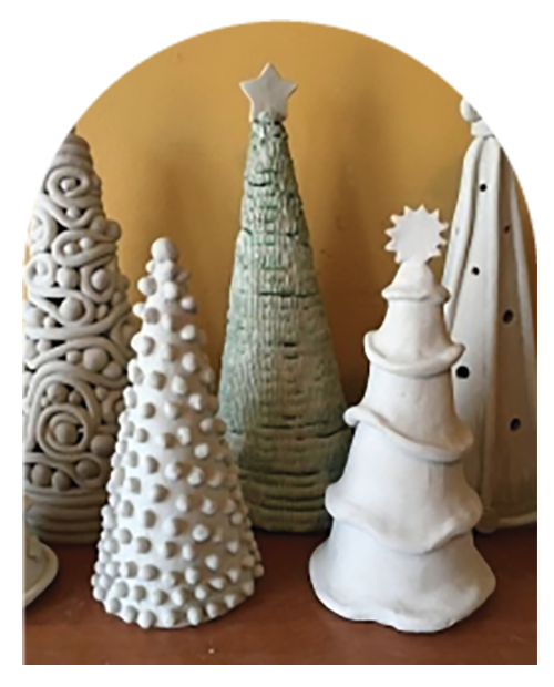 Five white ceramic Christmas trees