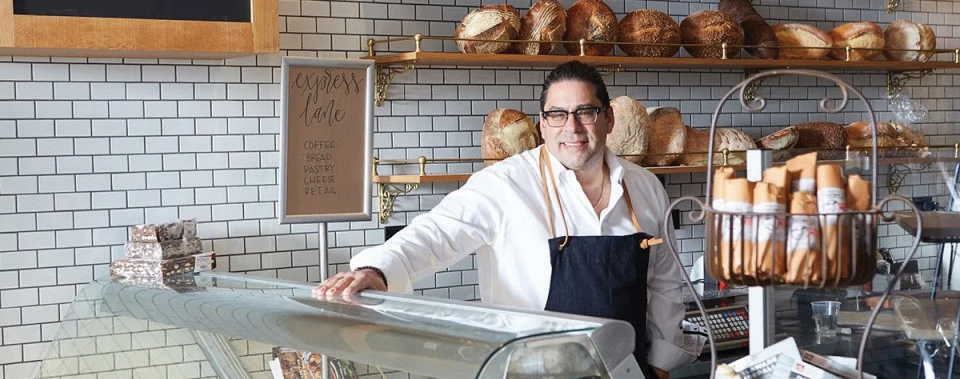 Nick Ambeliotis of Mediterra Bakery standing at counter